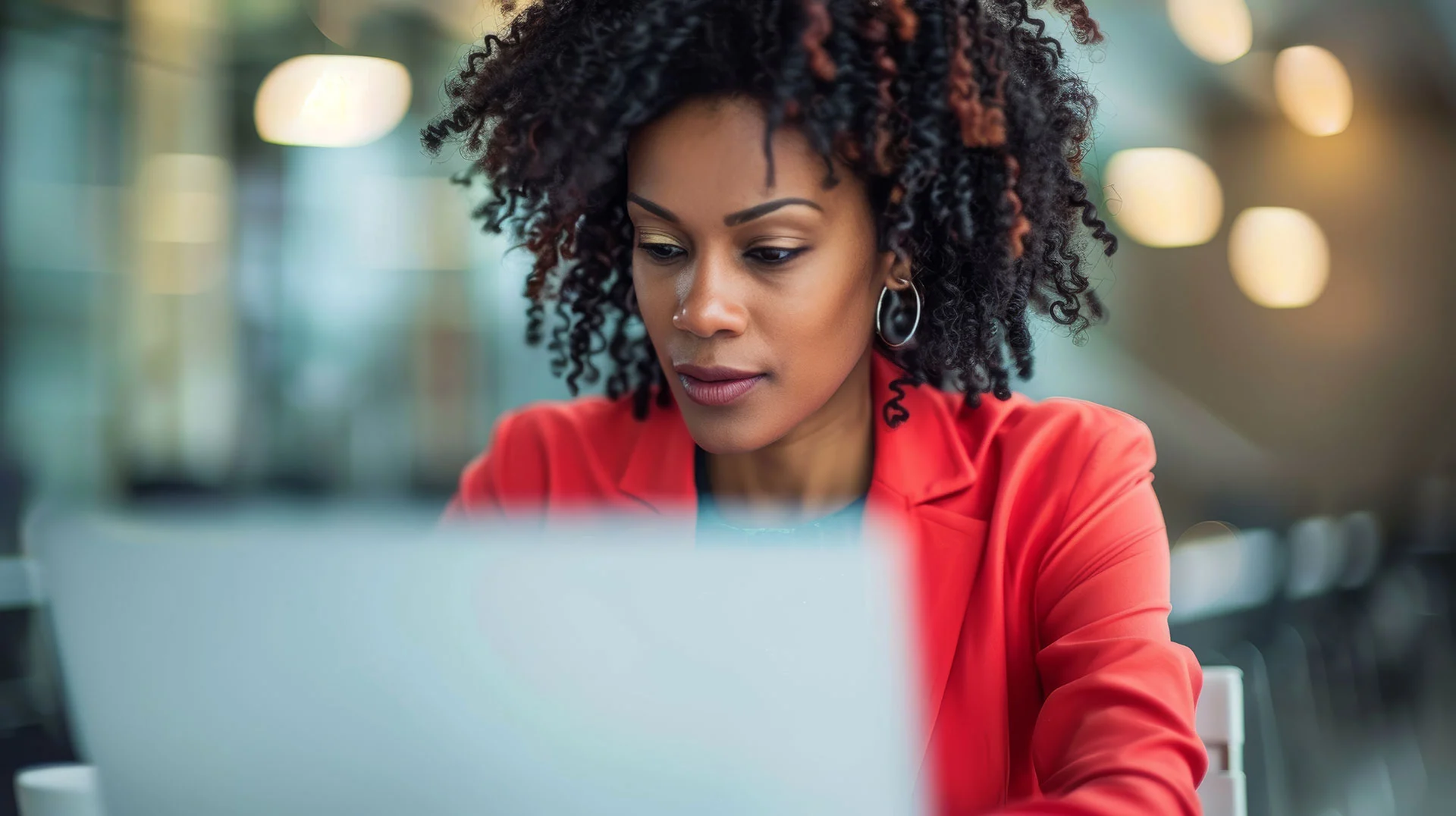 Black woman sitting at her laptop.